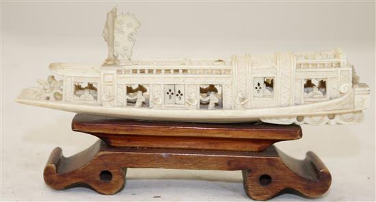 A Chinese ivory model of a boat, early 20th century, 15.5cm, wood stand